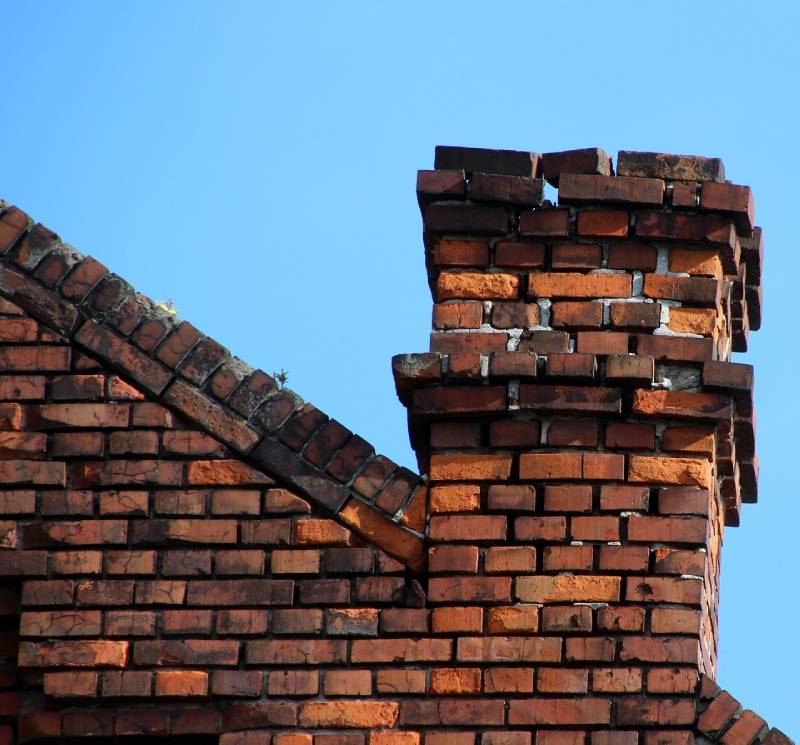 Signs Your Lewisville Home Needs a Chimney Inspection Damaged chimney on an Lewisville home showing cracks and missing mortar